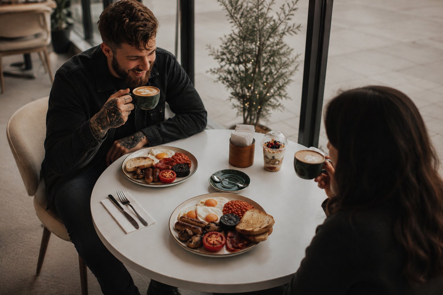 Friends sharing coffee and breakfast at Brew Lane Cafe
